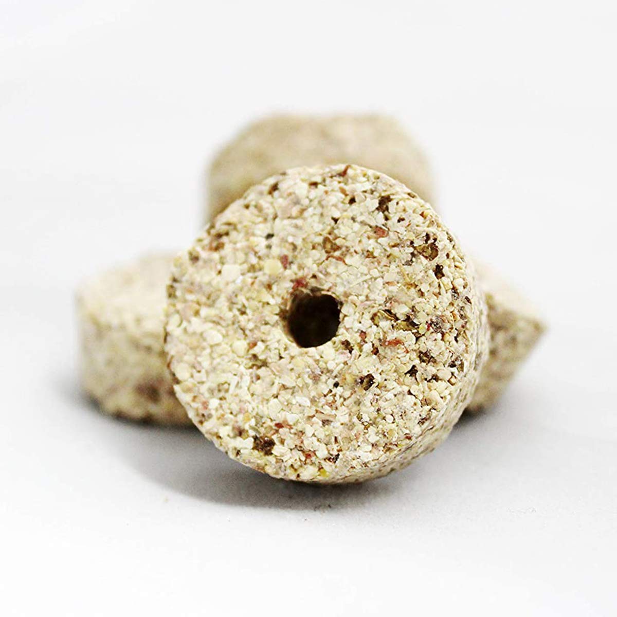 Close-up of RatX EcoClear discs highlighting natural ingredients