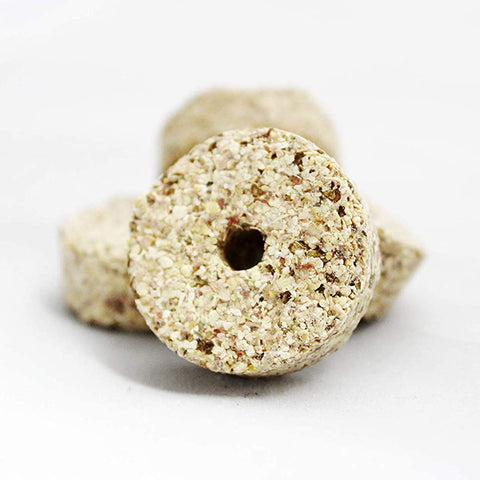 Close-up of RatX EcoClear discs highlighting natural ingredients