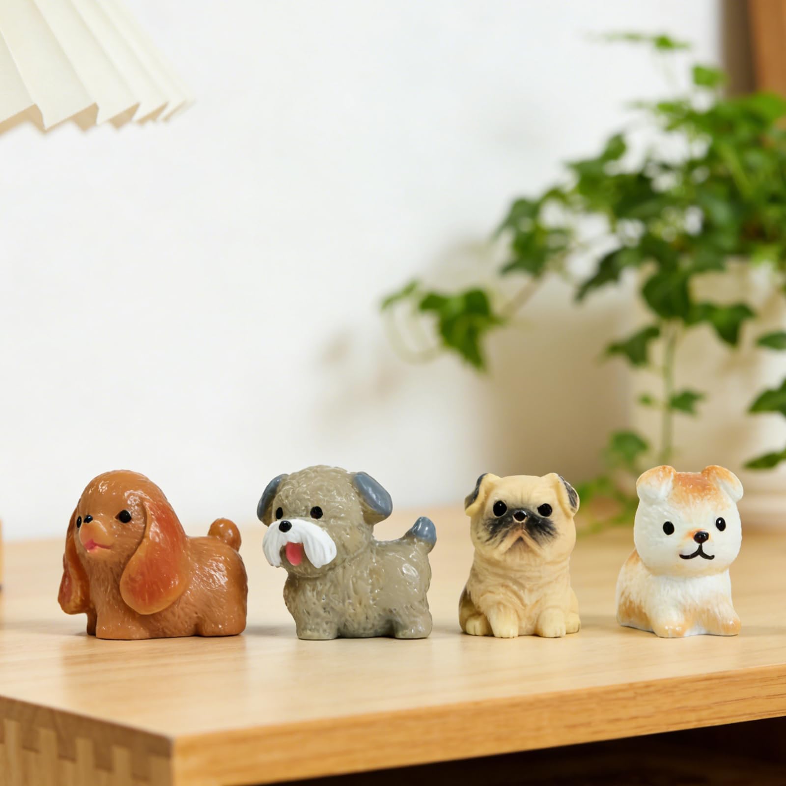 ResinGlow mini dogs perched on a planter for garden display