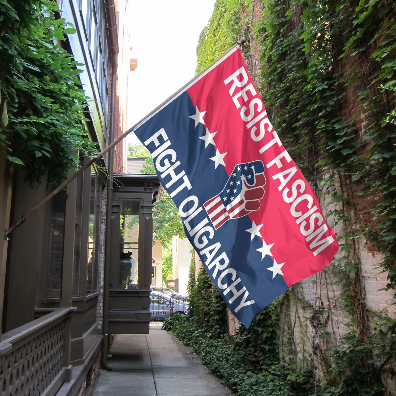 Resist Fascism flag perched in a garden for street-side display.