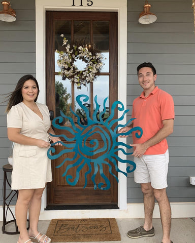 Riverside Designs outdoor-ready teal sun sculpture enhances porches and gateways.