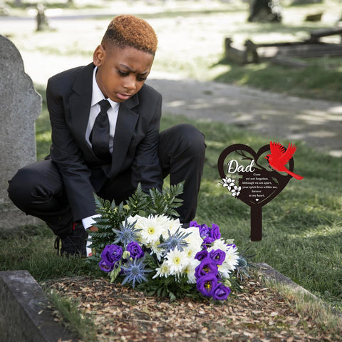 Rngmsi cardinal dad grave marker installation demonstrates easy soil placement outdoors.