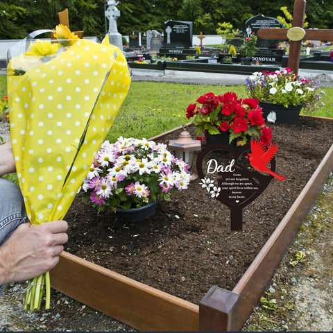Rngmsi cardinals-and-flowers motif enhances a respectful outdoor tribute.