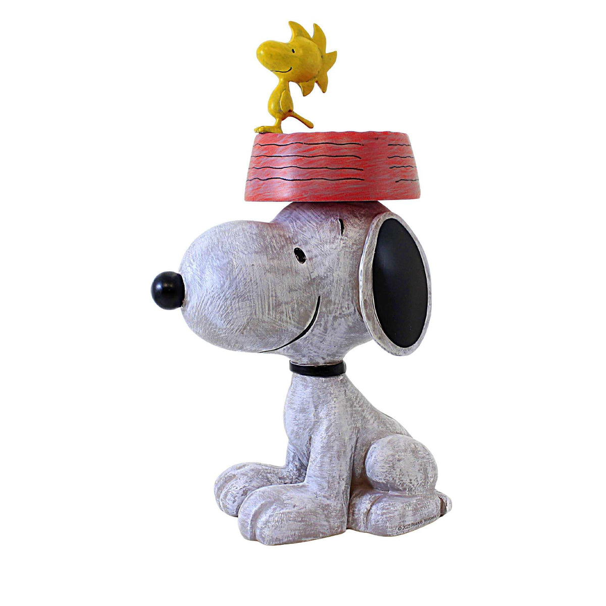 Roman Snoopy bird feeder in garden decor adds year-round outdoor charm.