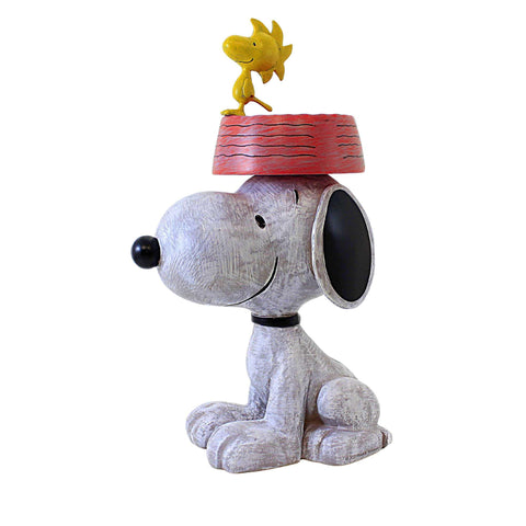 Roman Snoopy bird feeder in garden decor adds year-round outdoor charm.