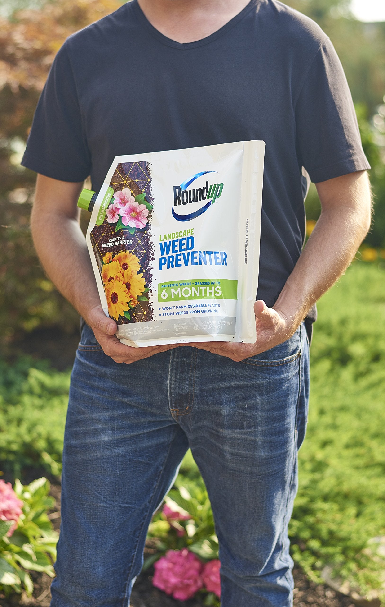 Roundup Landscape Weed Preventer applicator shown for even coverage near garden beds