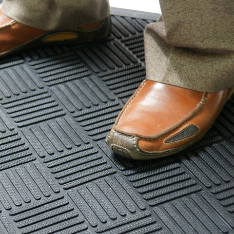 Rubber-Cal Dura-Scraper Checkered resists slipping on wet outdoor areas.