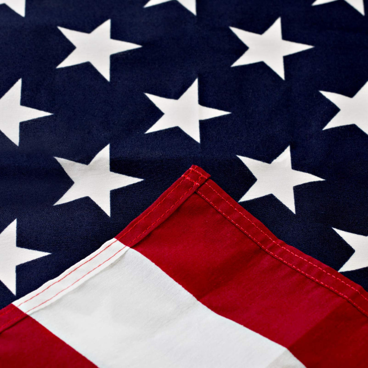 Rushmore Rose USA outdoor 3x5 flag unfurls with vivid color in sunlight.