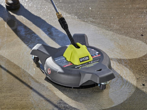 RYOBI surface cleaner in action on a driveway, reducing cleanup time.