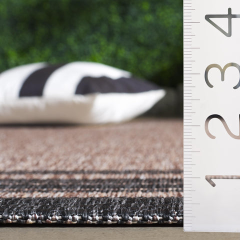SAFAVIEH Courtyard natural-black runner in backyard spaces suited for outdoor living.