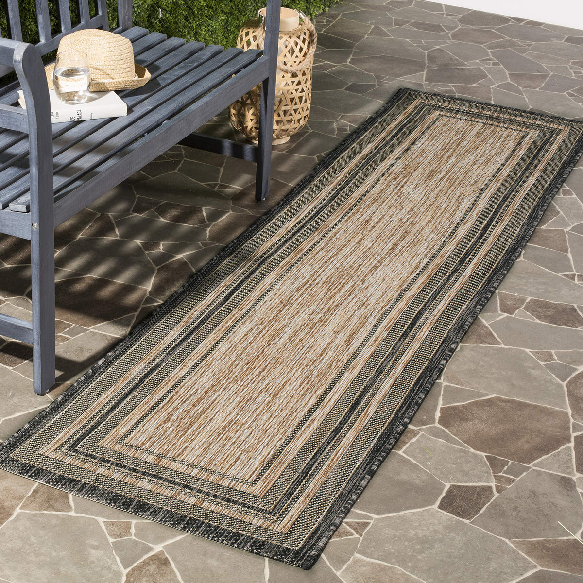 SAFAVIEH Courtyard outdoor runner in natural and black for patios and high-traffic areas.