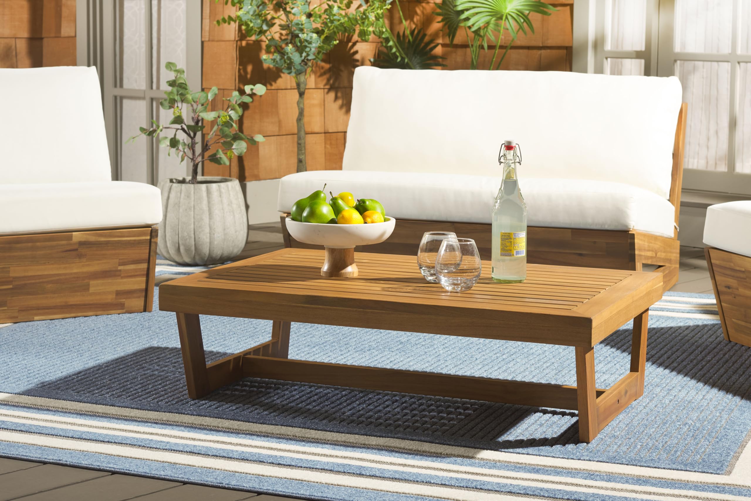 Safavieh Lynn natural brown acacia wood table enhances garden seating area