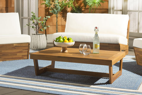 Safavieh Lynn natural brown acacia wood table enhances garden seating area