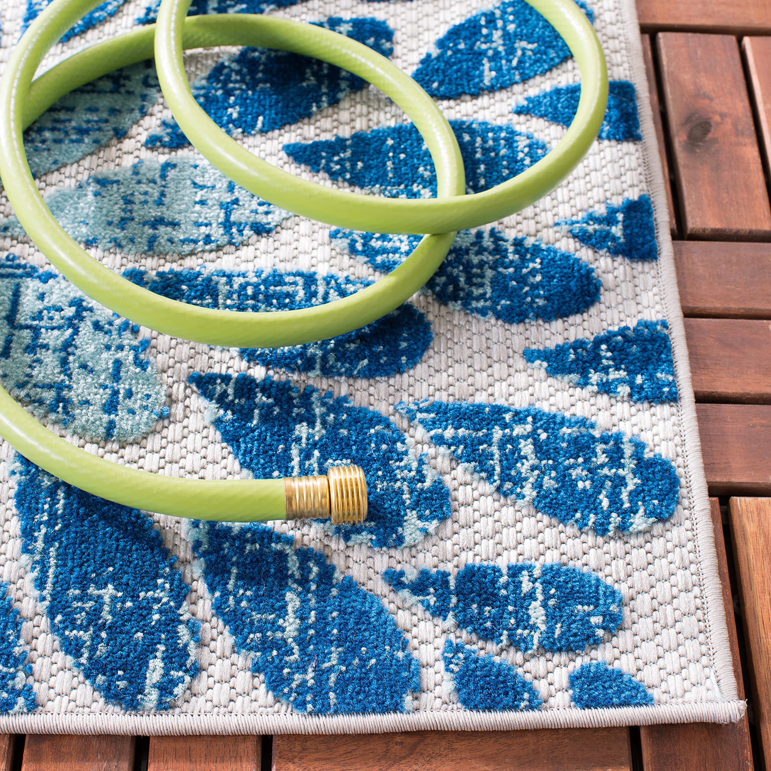 Safavieh Cabana rug in backyard dining space showcases simple hose-cleaning.