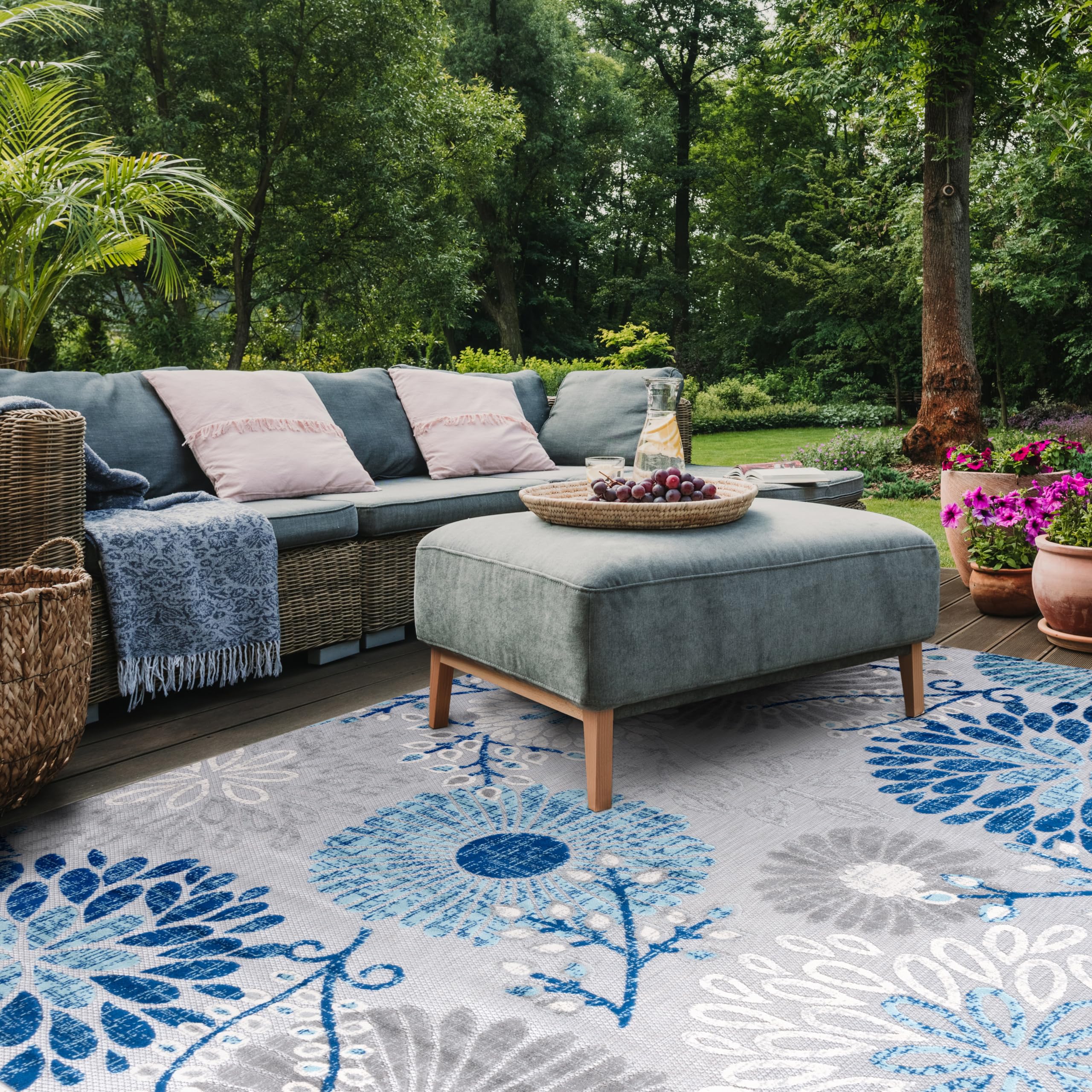 Safavieh Cabana rug being rinsed with a hose demonstrates quick outdoor cleaning.