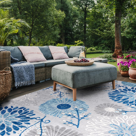 Safavieh Cabana rug being rinsed with a hose demonstrates quick outdoor cleaning.