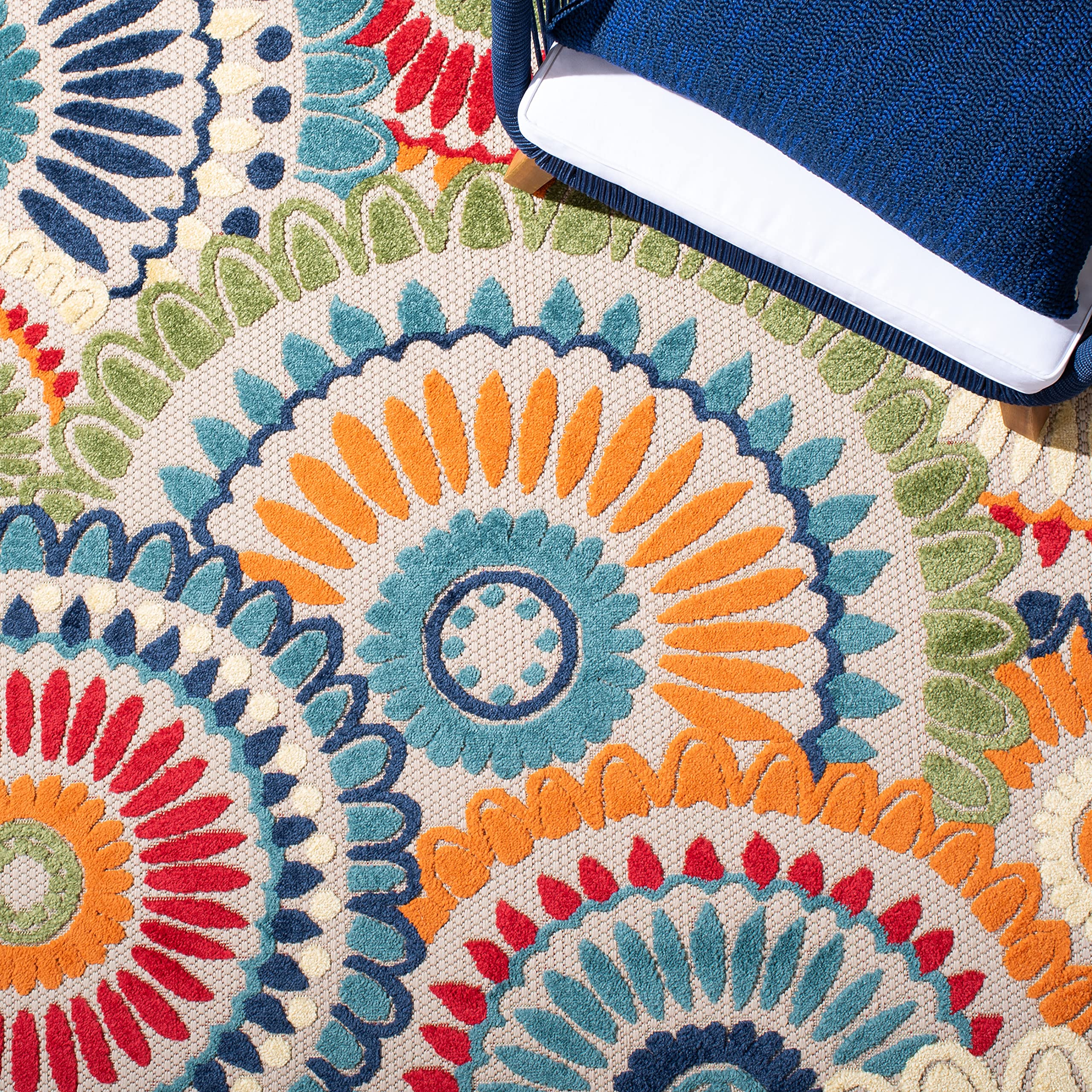 Safavieh Cabana rug being rinsed with a hose, demonstrating easy outdoor cleaning.