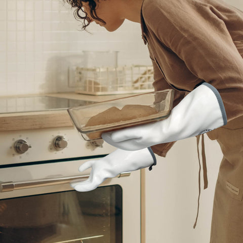 Home chef using Lingli mitts for grilling and cooking tasks