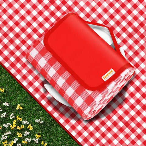 SAMSIER picnic blanket laid flat on grass; waterproof and sandproof for family picnics.