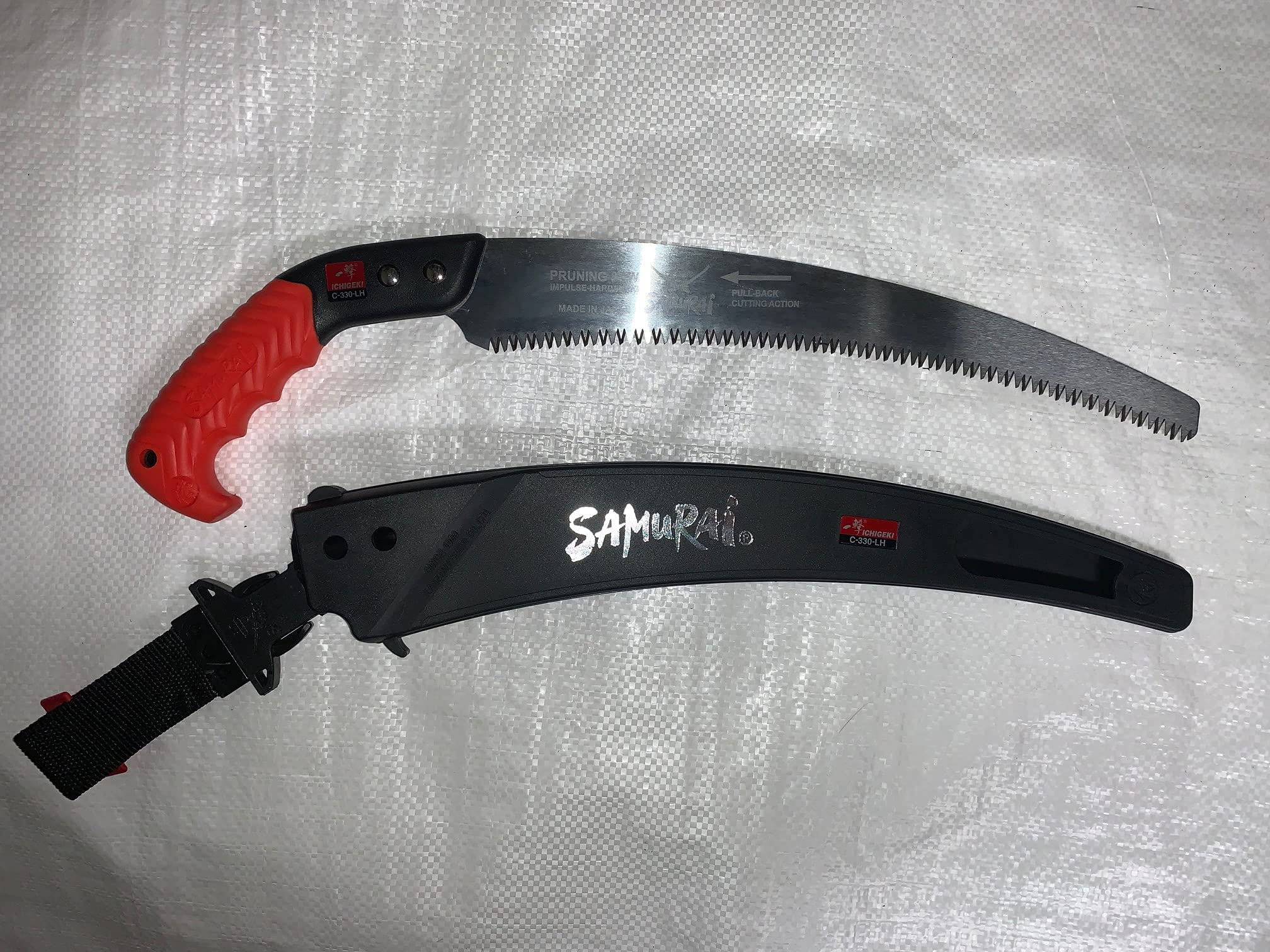 Samurai Kanzawa Ichigeki pruning saw blade close-up in use.