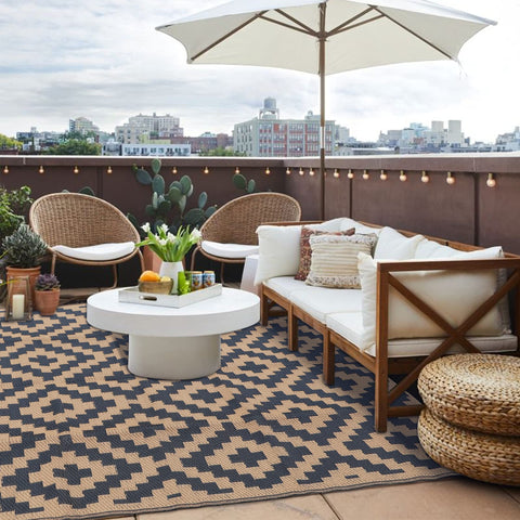 SAND MINE reversible mats on a deck, highlighting low maintenance outdoor rug use.