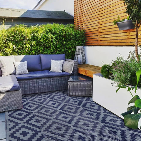 SAND MINE mat on a deck protects wood while hosting outdoor gatherings