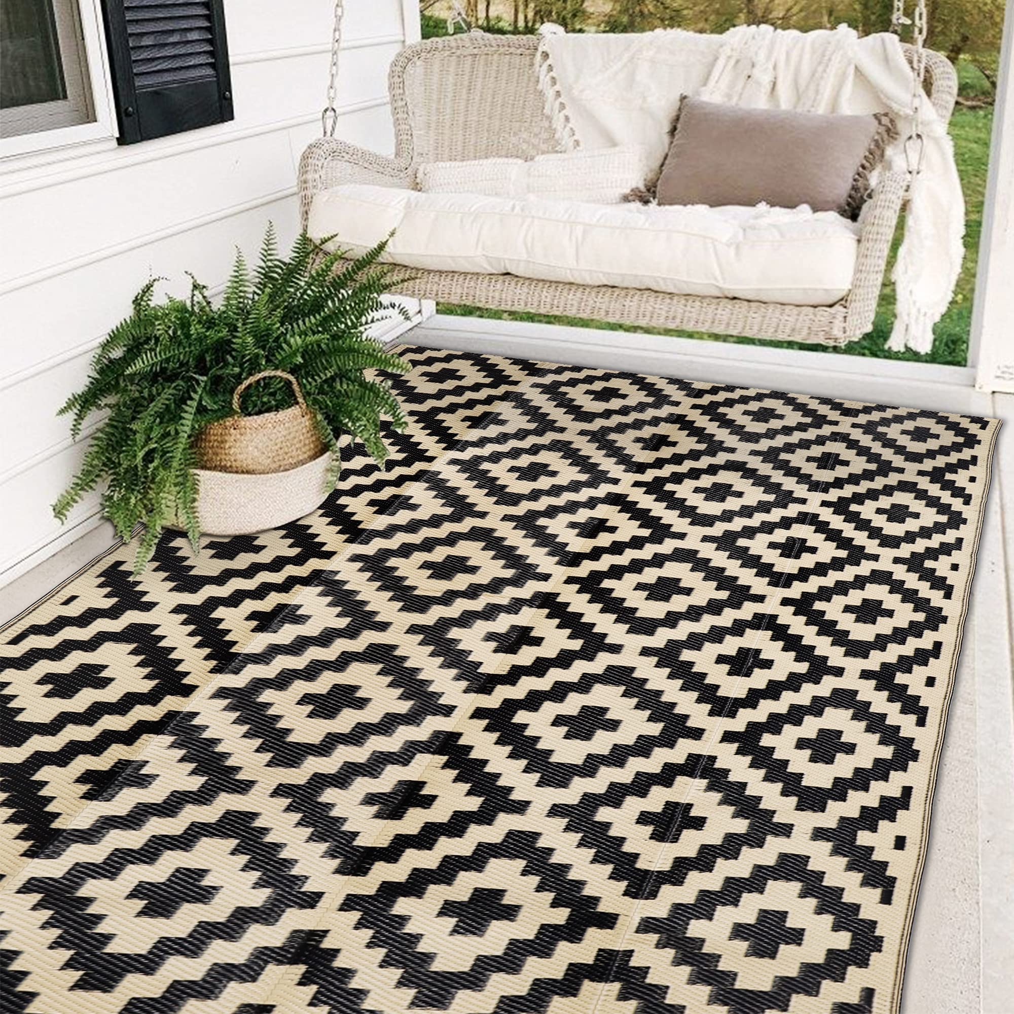 Sand MINE waterproof outdoor rug in black and beige for patios and decks, weather resistant.