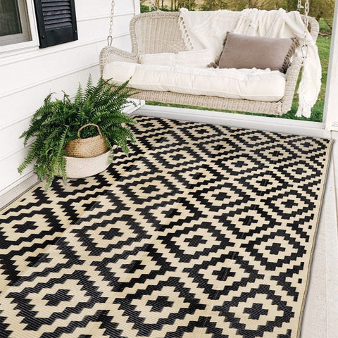 Sand MINE waterproof outdoor rug in black and beige for patios and decks, weather resistant.