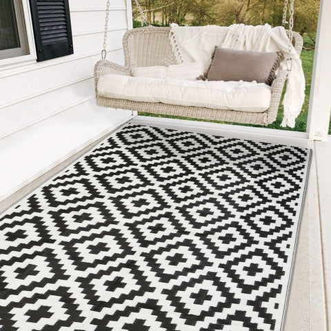 SAND MINE waterproof outdoor rug 5x8 laid on a sunlit patio for clean outdoor living.