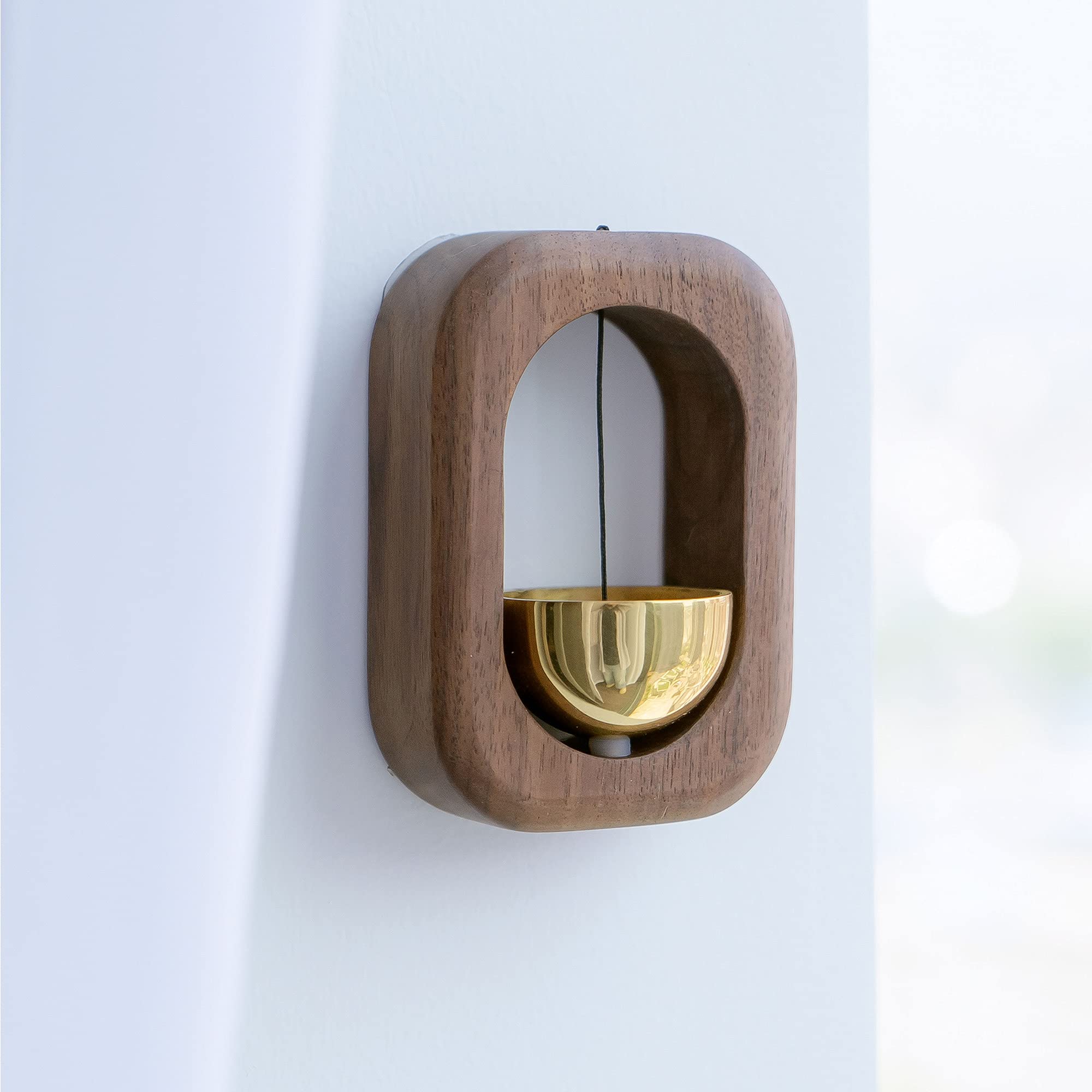 Sanosy doorbell on refrigerator walnut—nearby kitchen alerts.