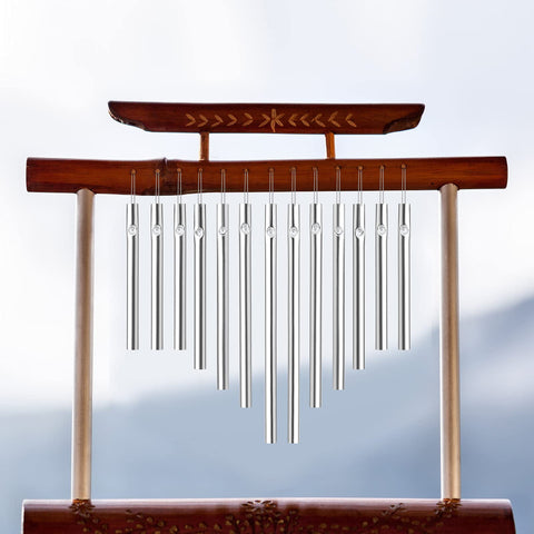 Sansheng wind chime tubes hanging on a porch ready to enjoy a breeze.