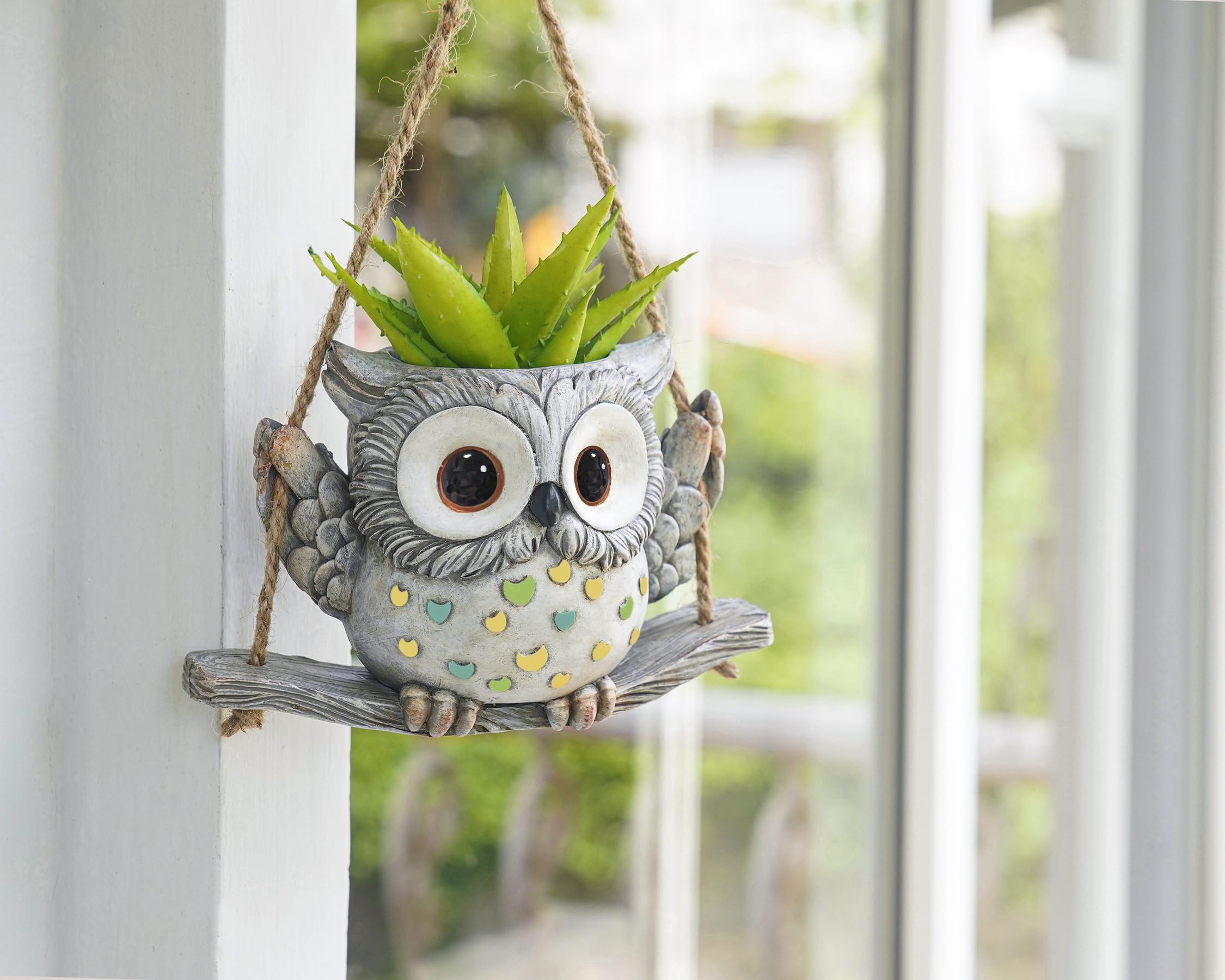 Saysmile Swing Owl planter in outdoor garden with bright light.
