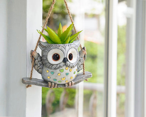 Saysmile Swing Owl planter in outdoor garden with bright light.