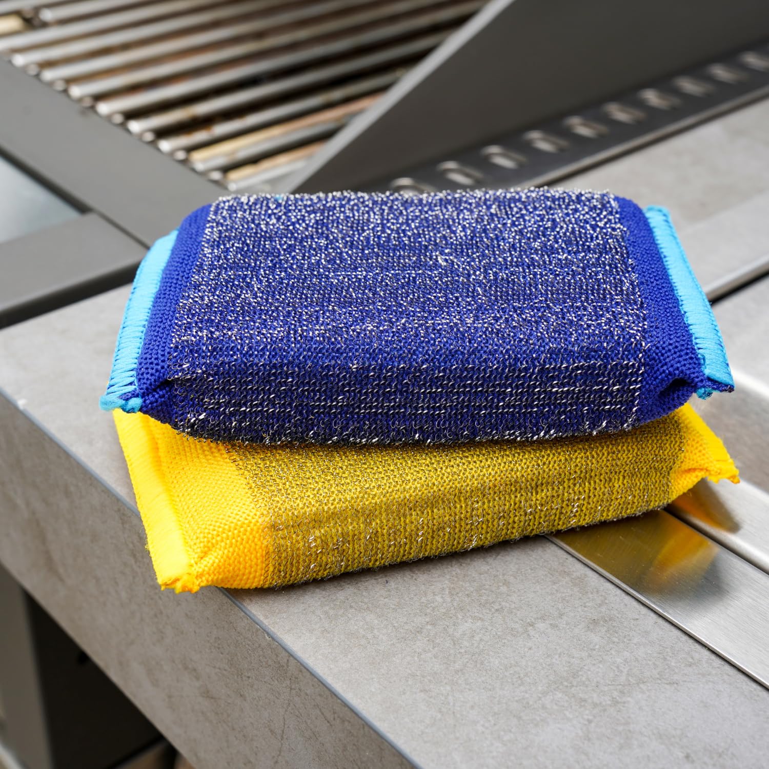 Two steel scour sponges tackle stubborn residue on grills and cookware.