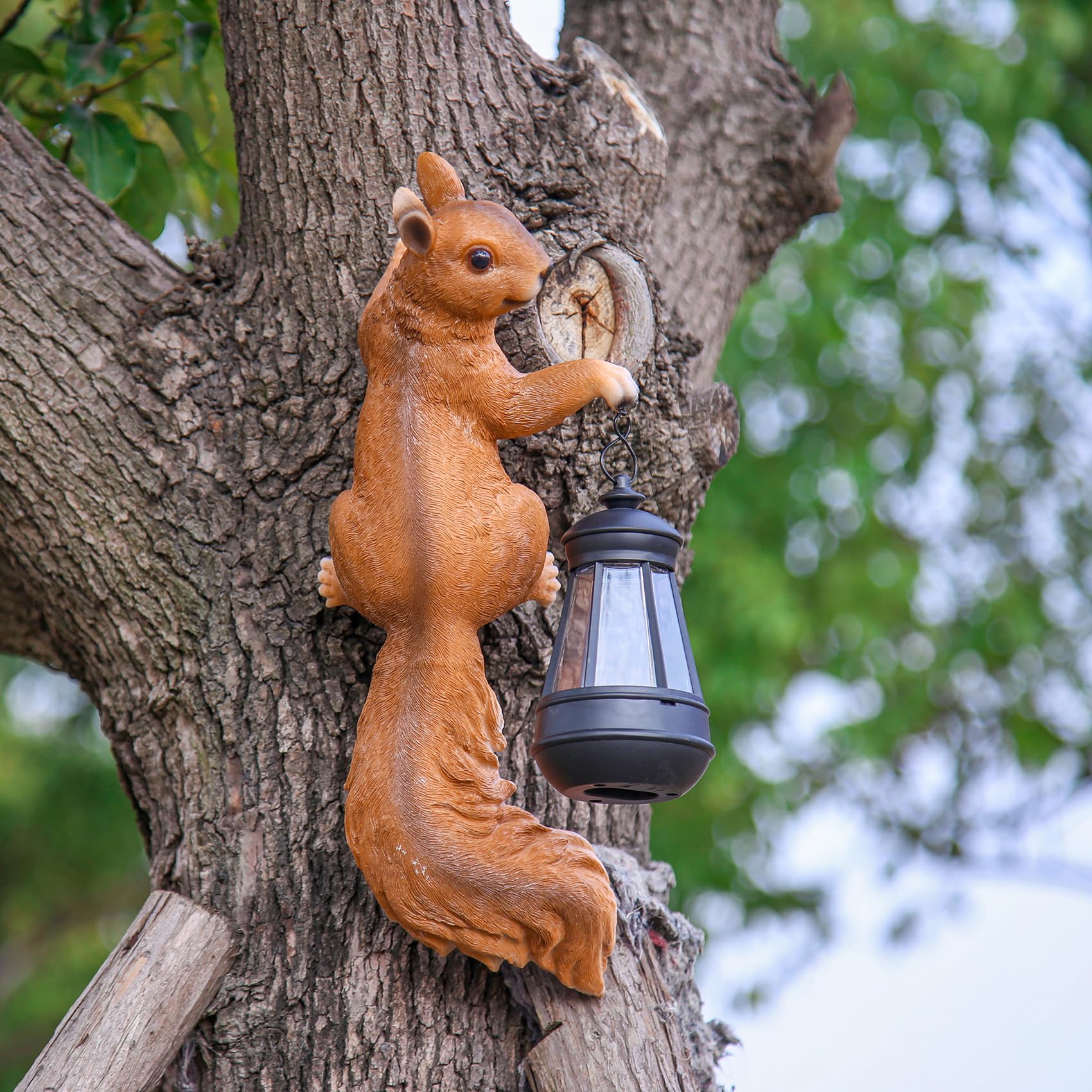 SHAODIE Squirrel lantern-holding sculpture adds warm dusk lighting to gardens.