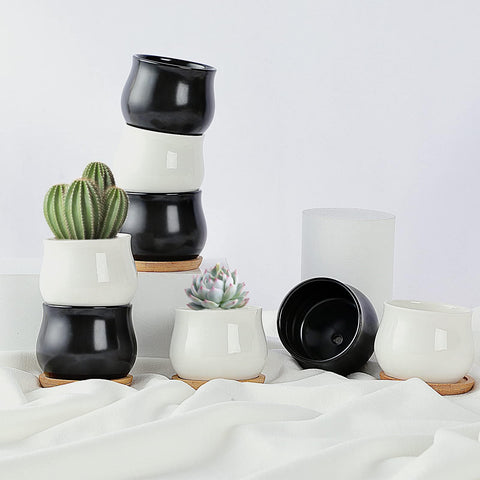 SHECIPIN set of two durable ceramic planters for small plants.