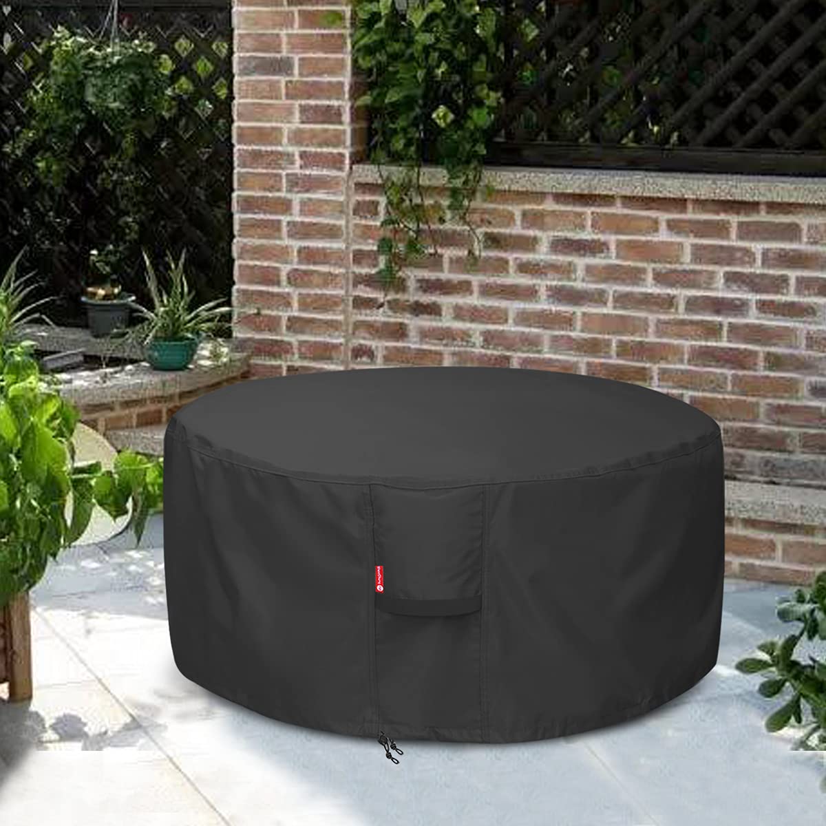 SheeChung fire pit cover in a patio setting helps keep the area tidy