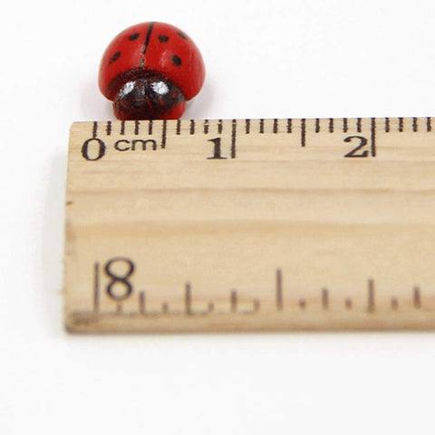 Shindel self-adhesive wooden ladybugs back for easy sticking to surfaces.