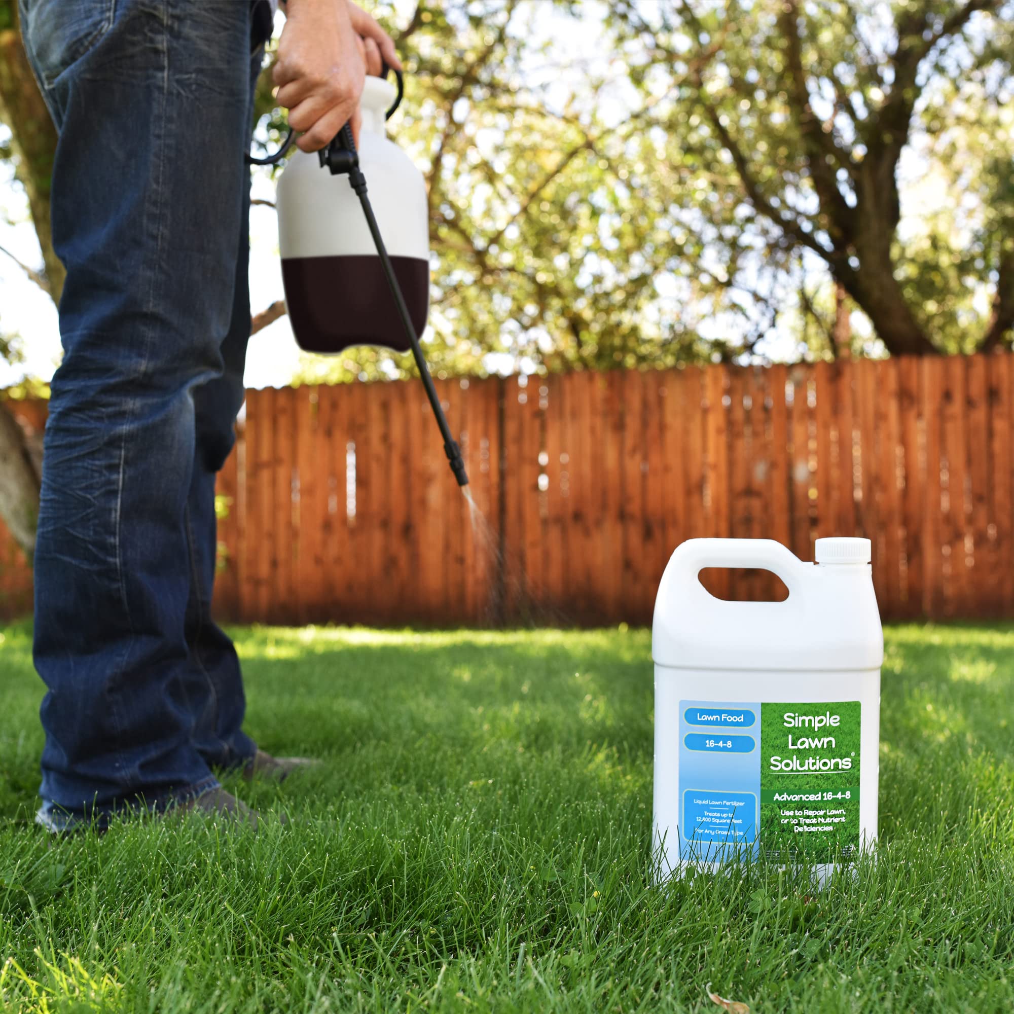 Applying Simple Lawn Solutions liquid fertilizer on a green lawn.