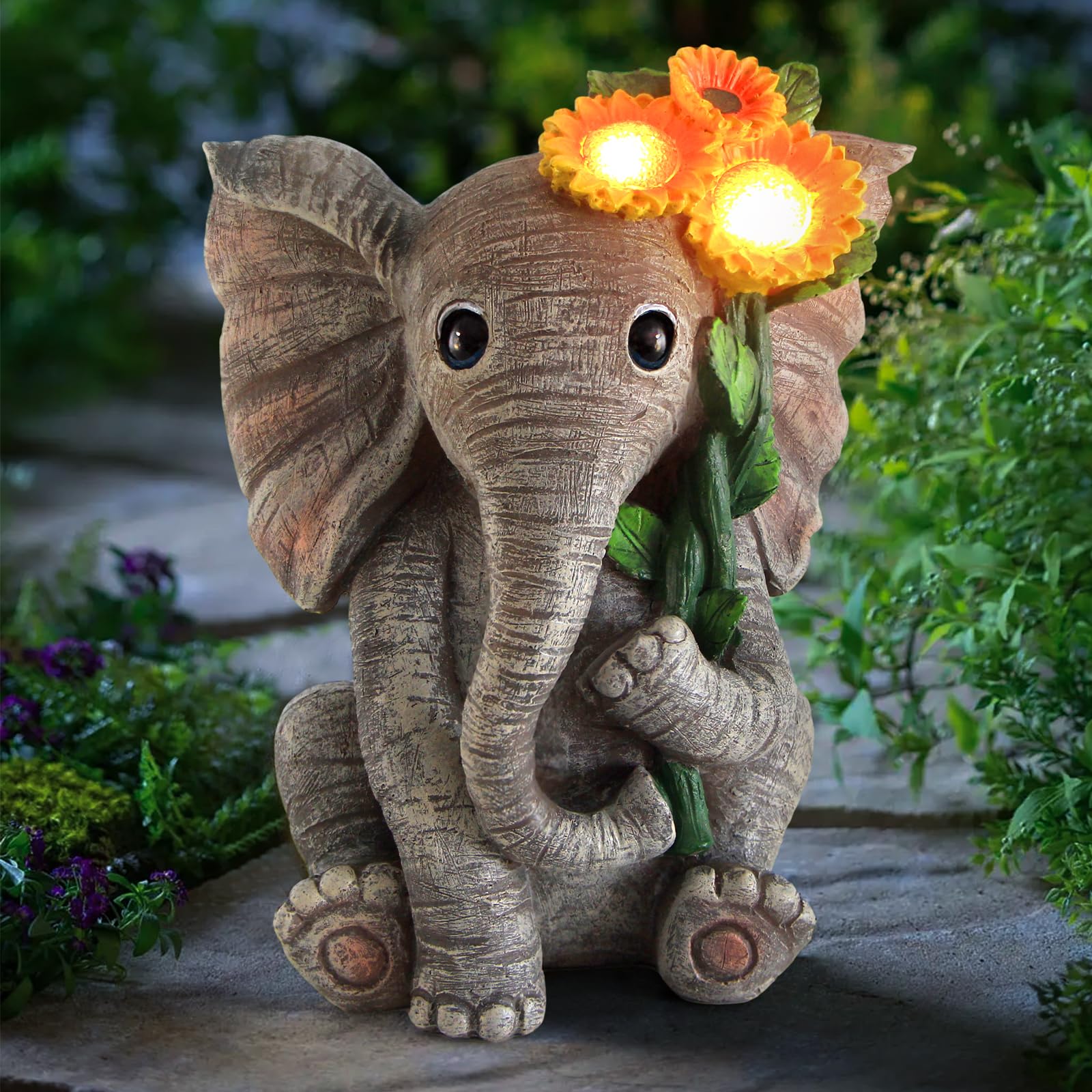 Sinhra elephant-sunflower statue in garden adds charm and optimism.