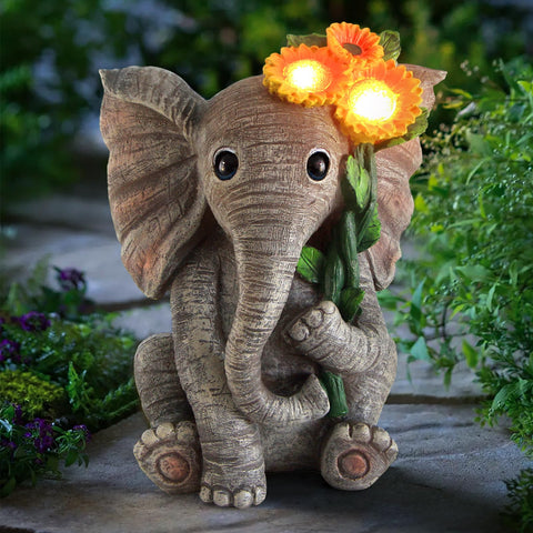 Sinhra elephant-sunflower statue in garden adds charm and optimism.