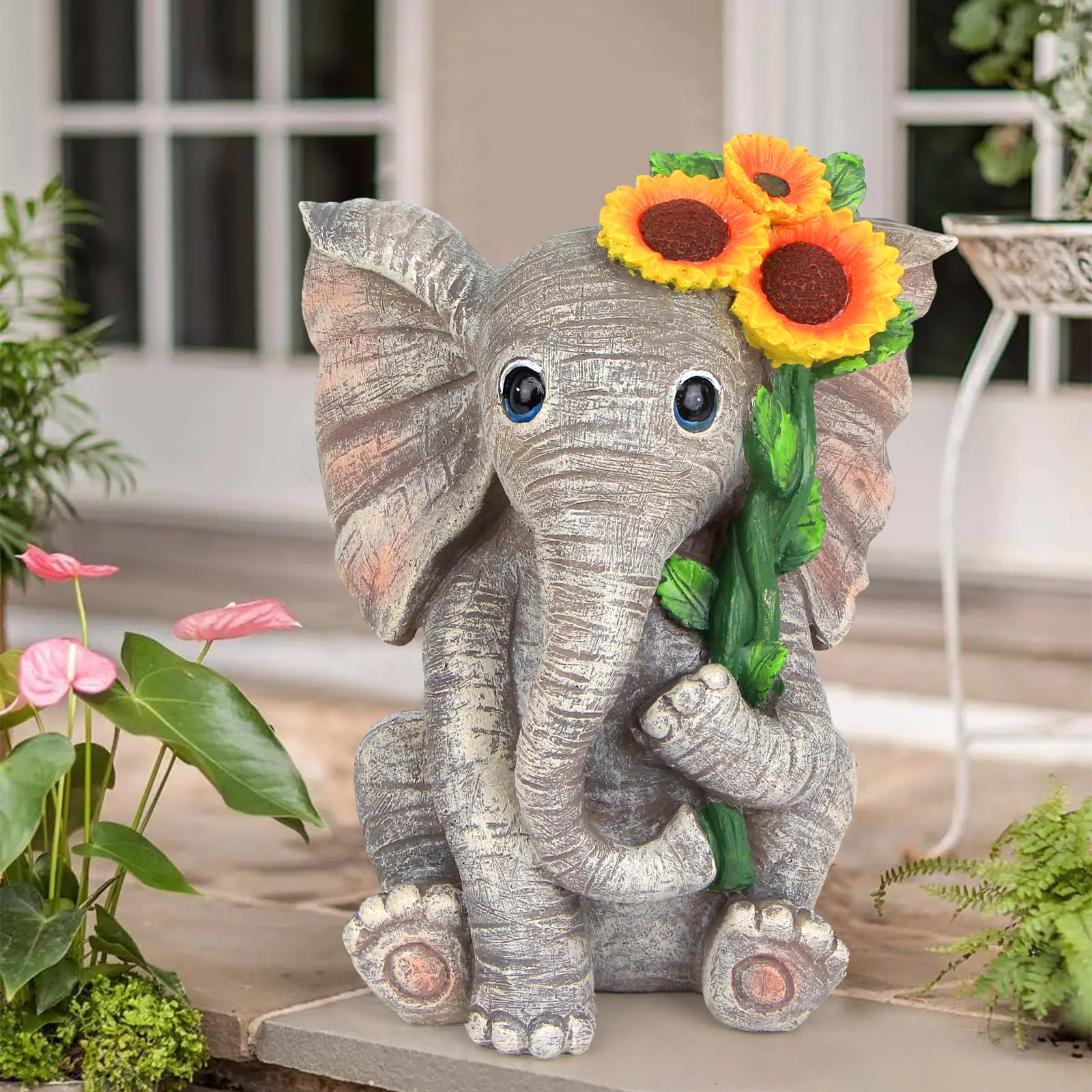 Sinhra solar-powered elephant statue lights pathways at night.