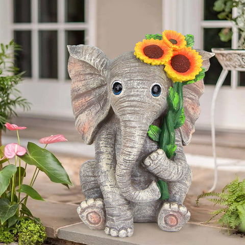 Sinhra solar-powered elephant statue lights pathways at night.