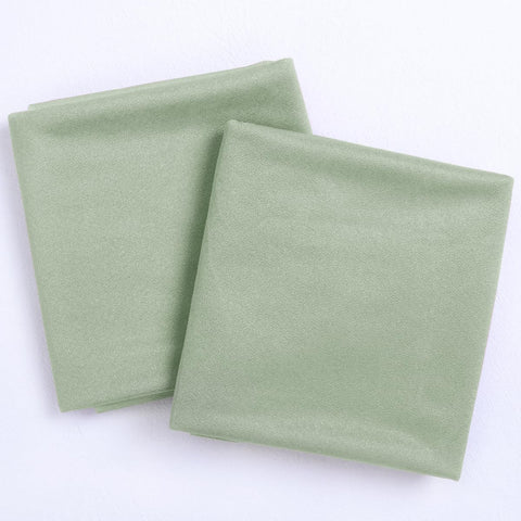 Socomi sage green arch drapes enhance arbor or chuppah with delicate folds