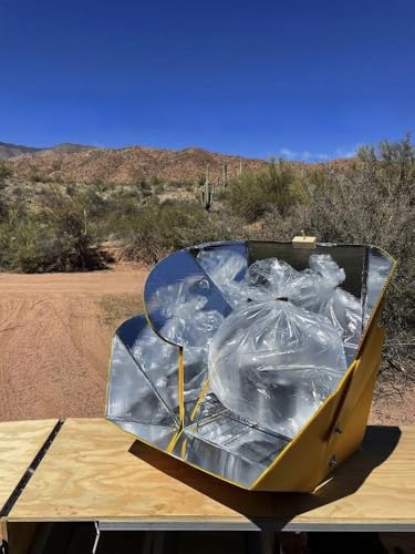 SOL COOK solar cooker in sunlight powering outdoor meals.