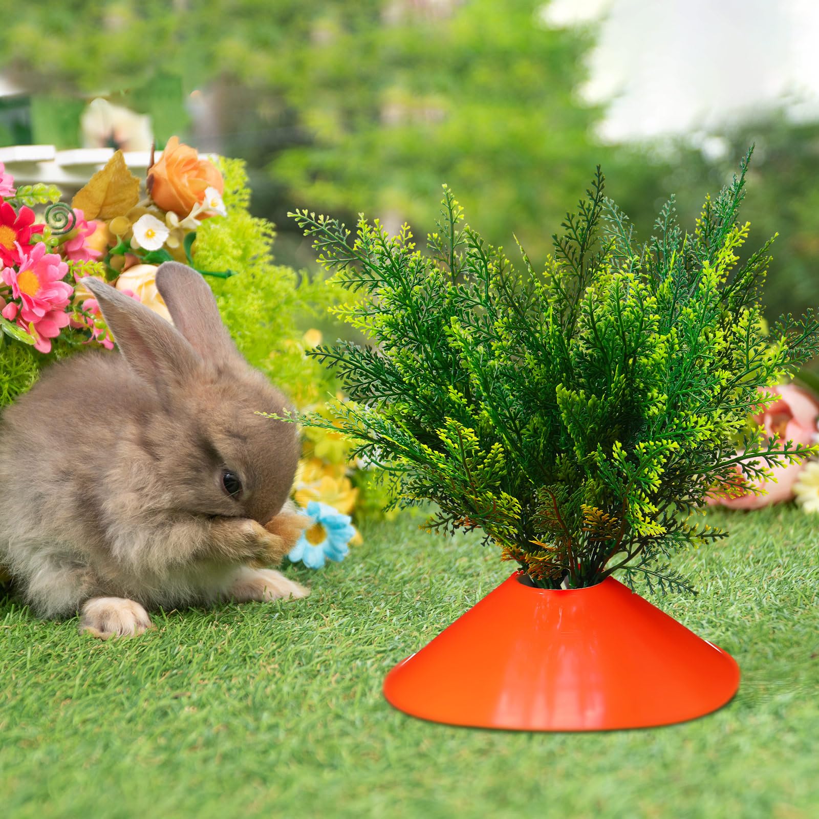 Solsew Easter carrot decorations brightening a garden bed and path.