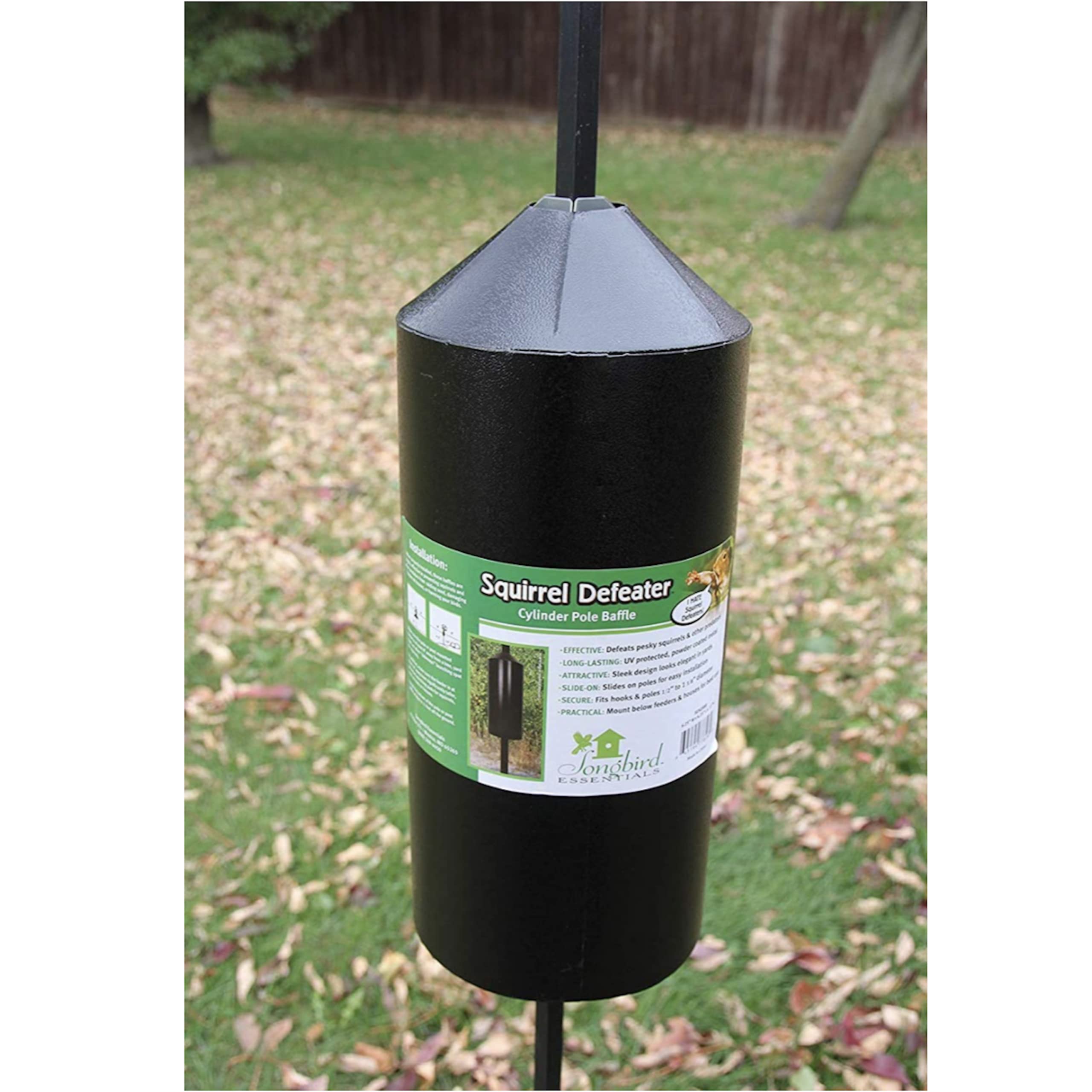 Songbird Essentials Squirrel Defeater baffle set up in a backyard.