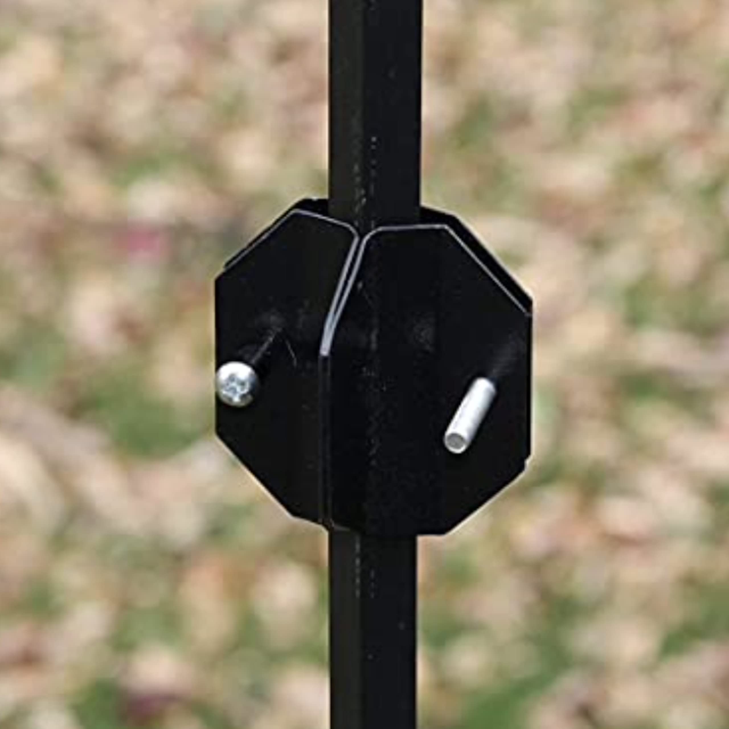 Songbird Essentials Squirrel Defeater baffle with stabilizer resting above ground.
