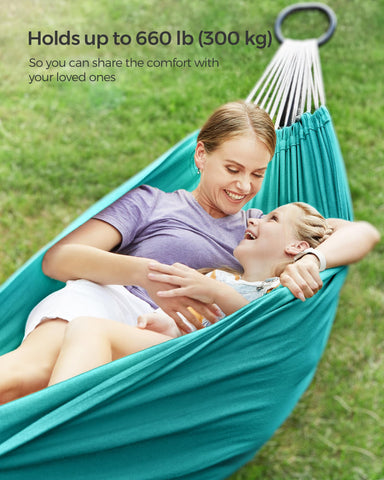 Turquoise Songmics hammock between trees on a terrace for relaxing outdoor comfort