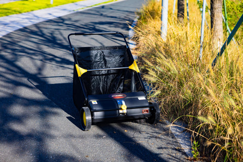 SPLENDOR LS-650A2 in action sweeping leaves along a driveway with effortless maneuverability